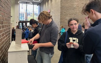 Students engage with questions from The Listening Cabinet in the Feintuch Family Lobby