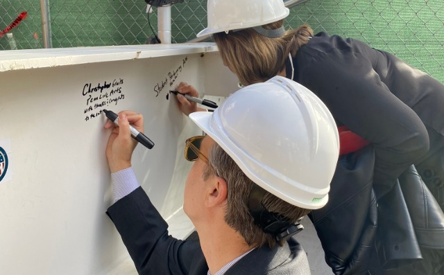 Penn Live Arts Executive & Creative Director Christopher A. Gruits signing Platt Center beam